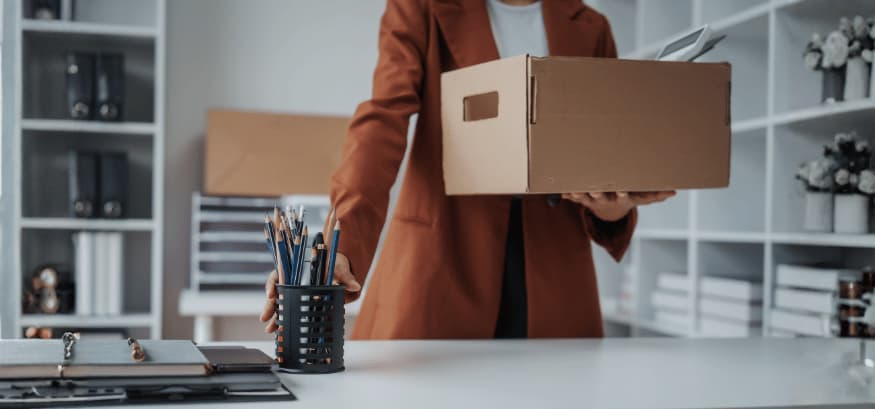 woman packing up desk at work