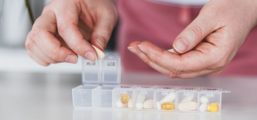woman organizing pills