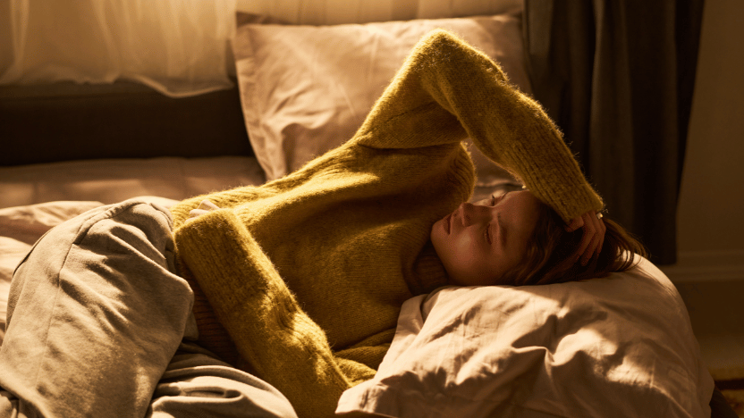 woman with pmos laying in bed