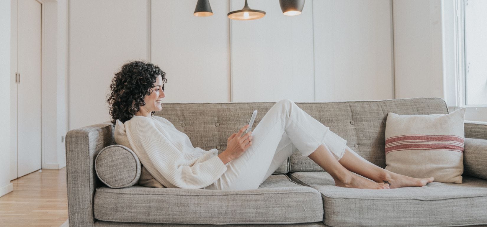 Woman sitting on couch reading