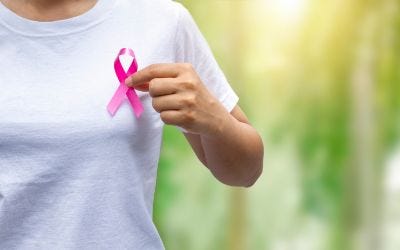 breast cancer ribbon pin on woman