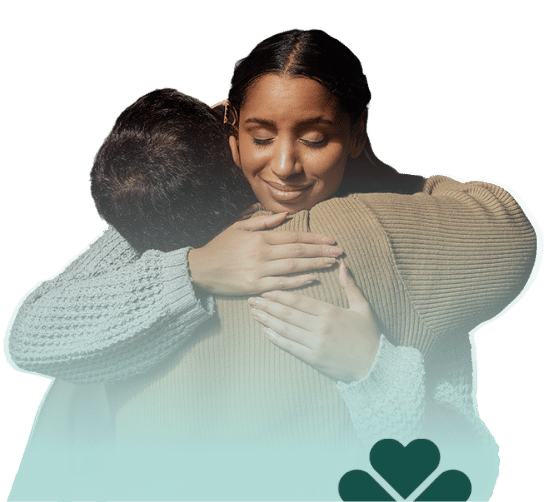 cargiver hugging loved one with mint gradient