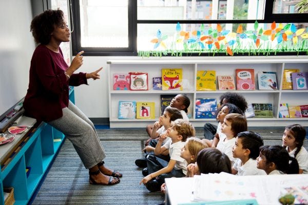 Childcare worker in classroom teaching children
