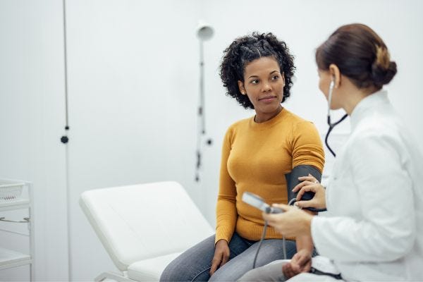 Woman talking to doctor about hypothyroidism and urinary incontinence