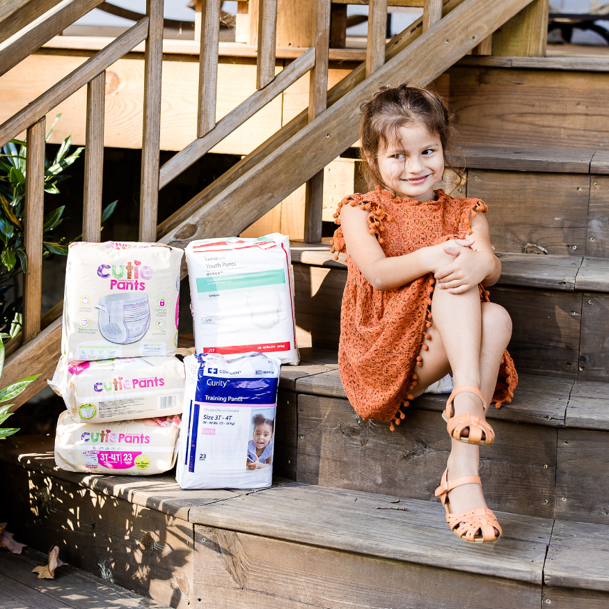 girl with packs of diapers