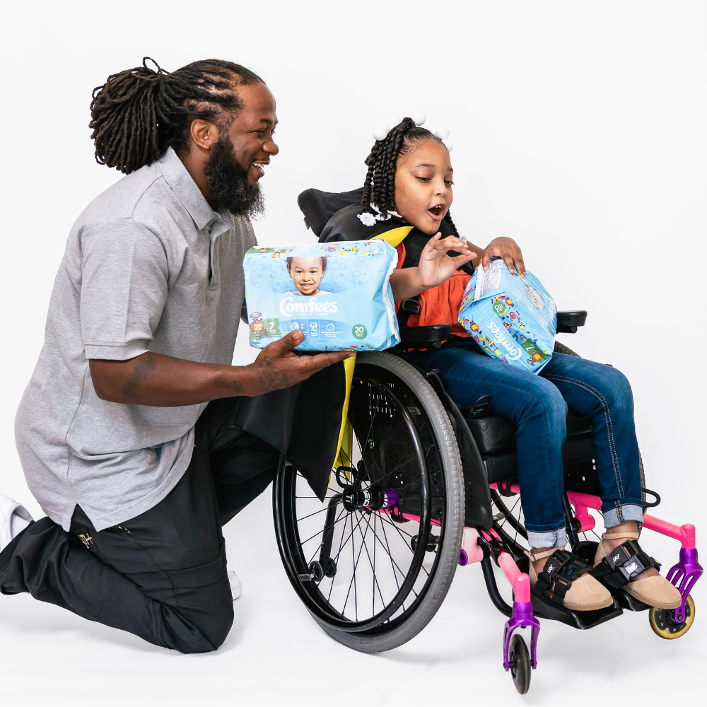 father holding incontinence products with daughter