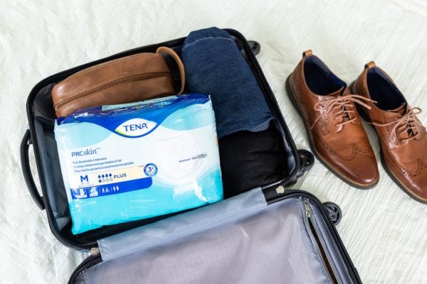 Men's incontinence products inside suitcase