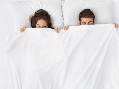 Couple in bed with incontinence