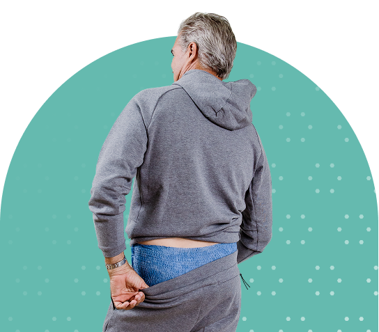 white adult man pulling pants up with adult diaper on
