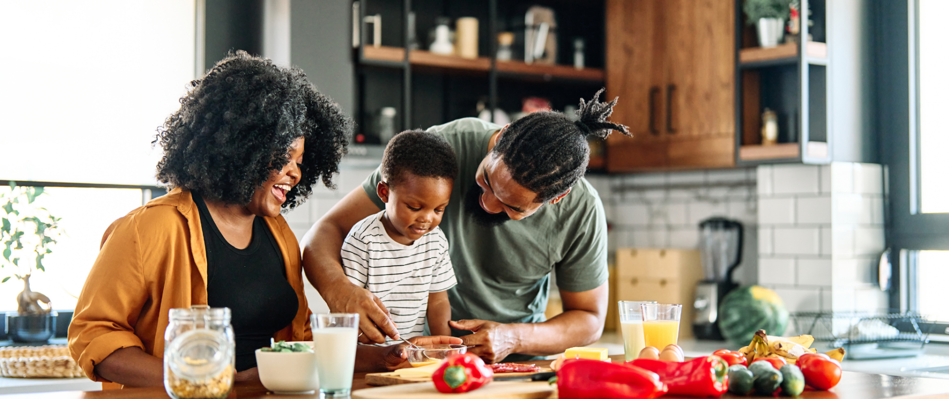 parents with child making dinner