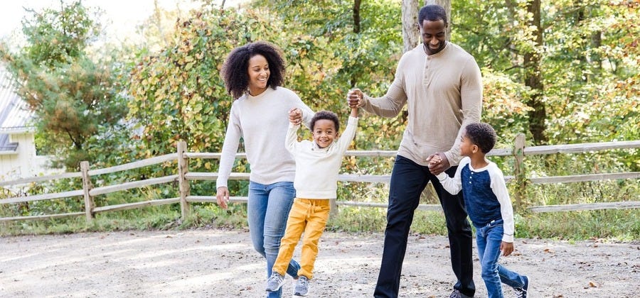 Family walking happily with child with autism