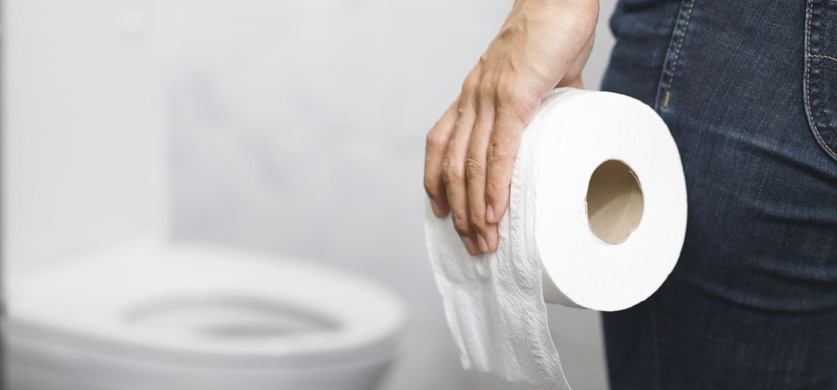 person holding toilet paper roll