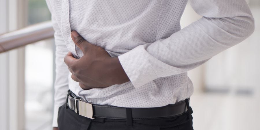 Person holding their stomach as if they're in pain.