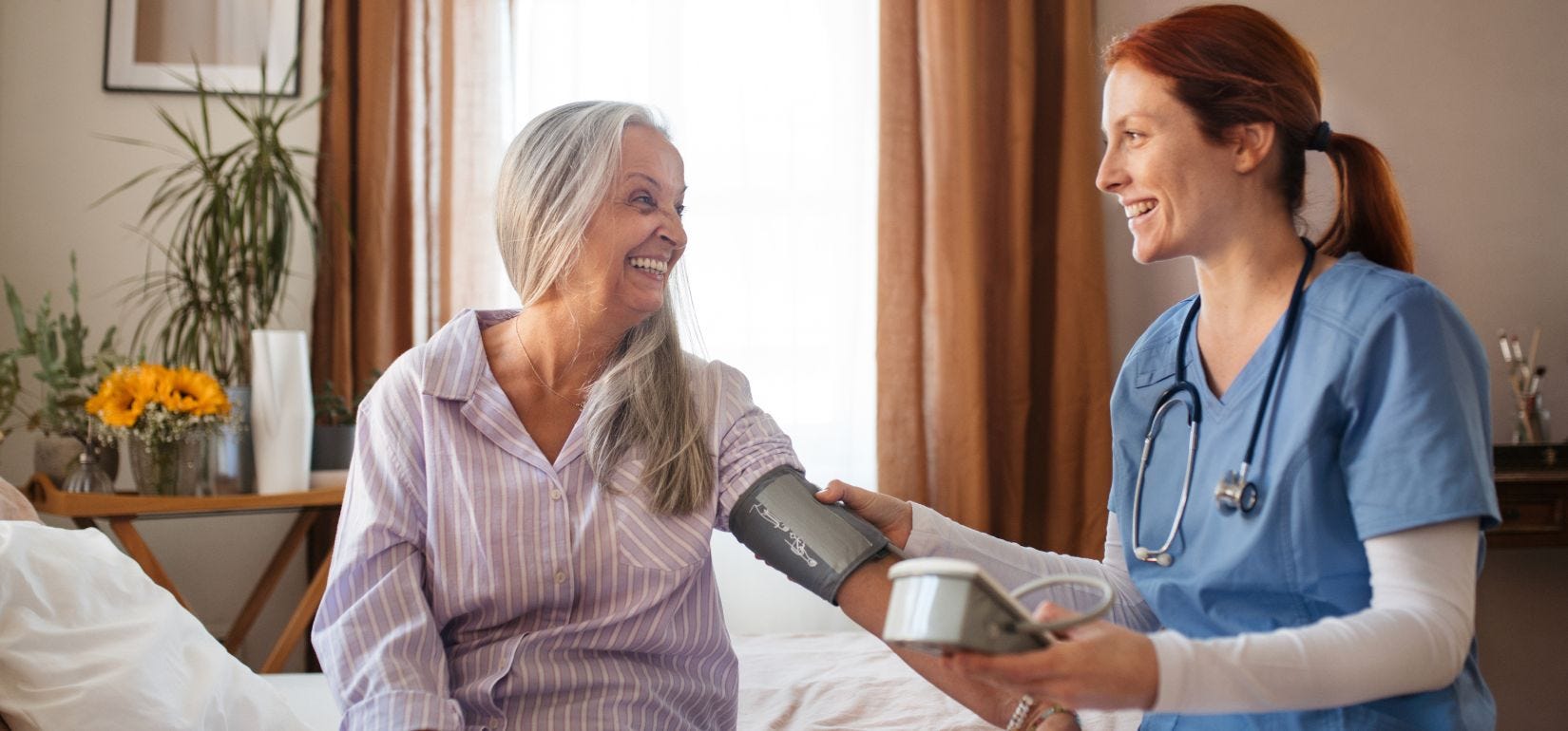 Caregiver checking an elderly patients vitals