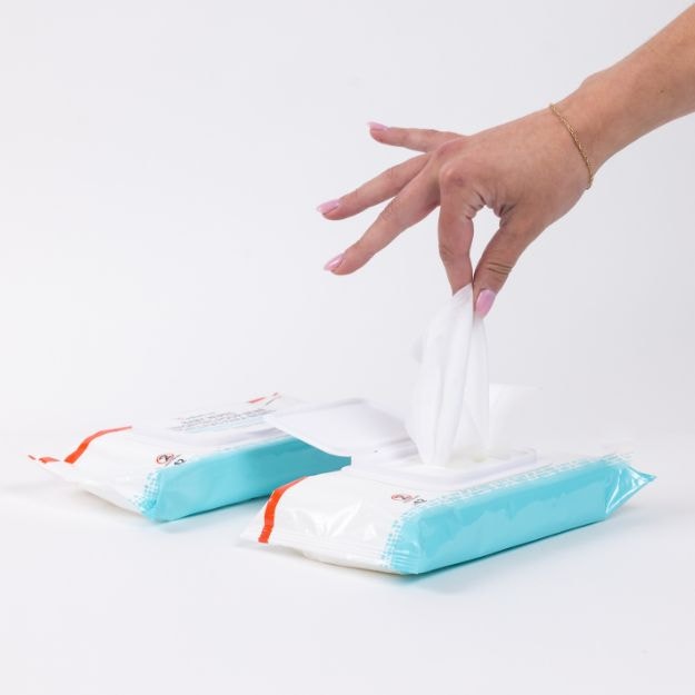 adult incontinence wipe being pulled from pack