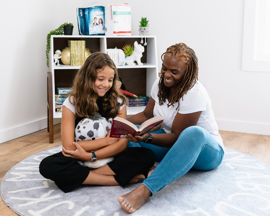 woman and child reading with incontinence products in background