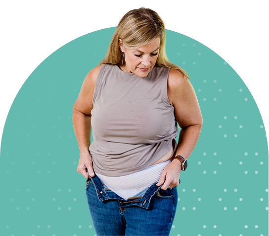 white adult woman pulling pants up with adult diaper on