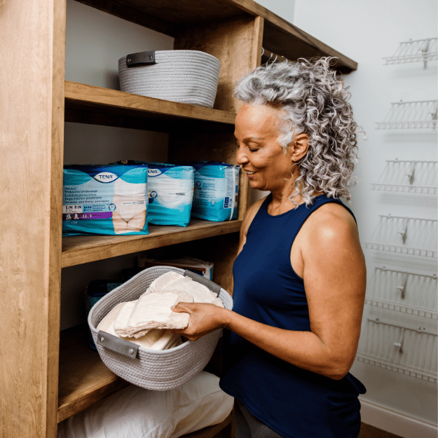 elderly woman holding an adult diaper
