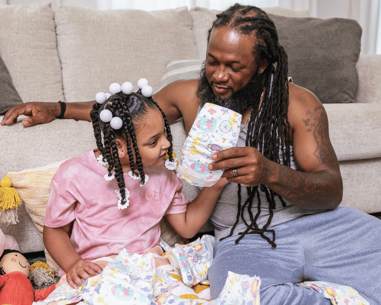 father and daughter holding youth pull on